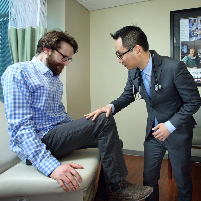 Tae Chung tests Matt Darnell’s reflexes on a follow-up visit for myositis care. Darnell says he wishes more patients with his condition were aware of the benefits of early physical activity.
